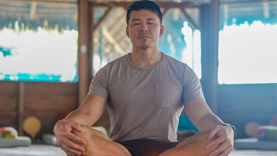 Man meditating cross-legged during a personal-growth retreat in South America